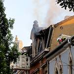 image: smoke rising above the rooftops