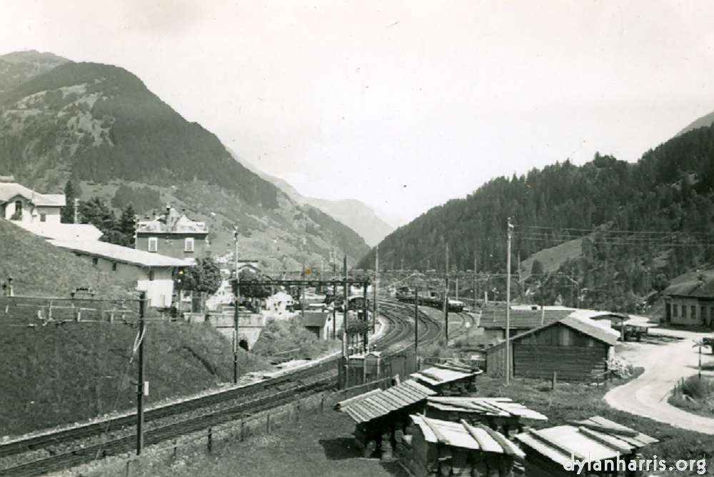 image: Photo: Looking East from Airolo. Shewing the Railway just about to enter the Southern end of the Gotthard Tunnel.