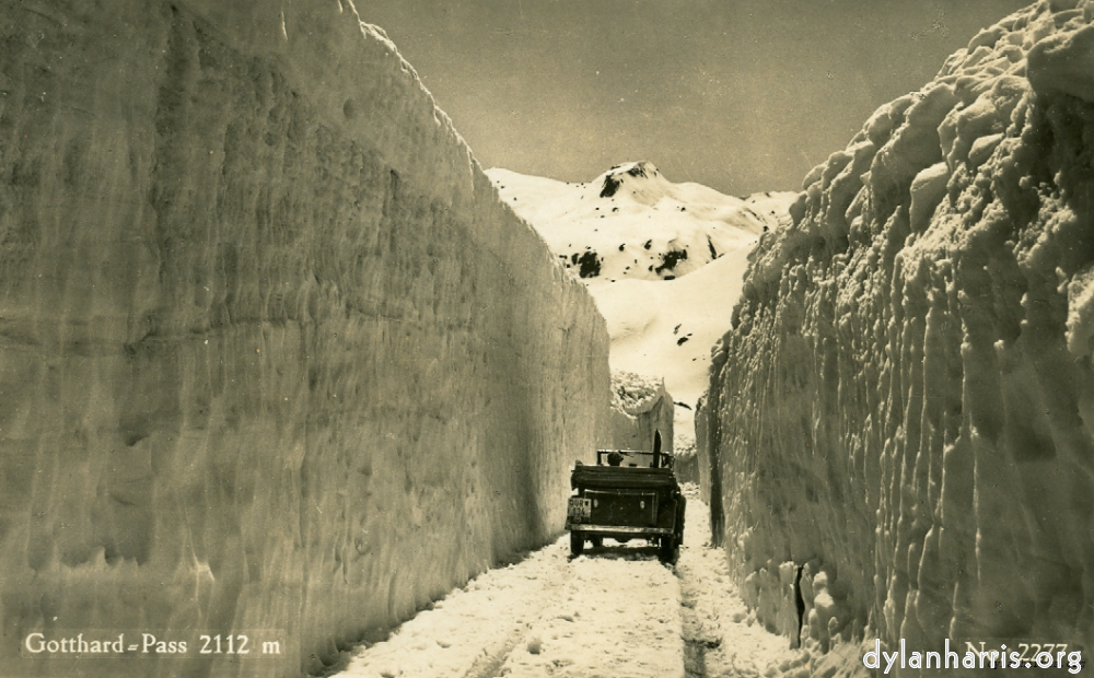 image: Postcard: Gotthard=Pass 2112m No. 2277 [[ The St Gotthard Pass after the Snows. This pass is closed for eight months of the year, from October to May inclusive. ]]