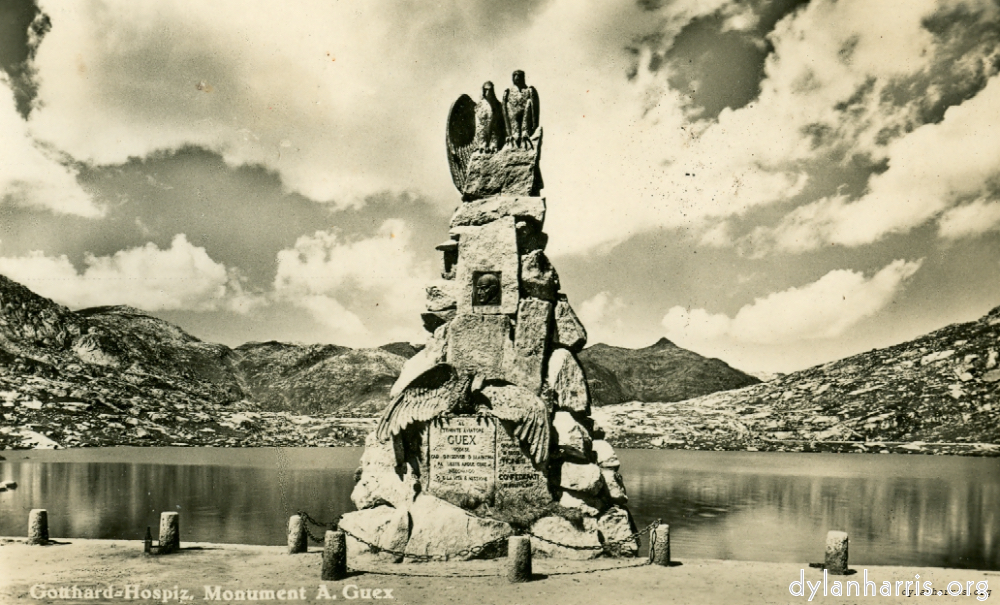 image: Postcard: Gotthard-Hospiz, Monument A. Guex [[ Monument to an Italian Airman outside the Hotel. St. Gotthard Pass, looking North. ]]