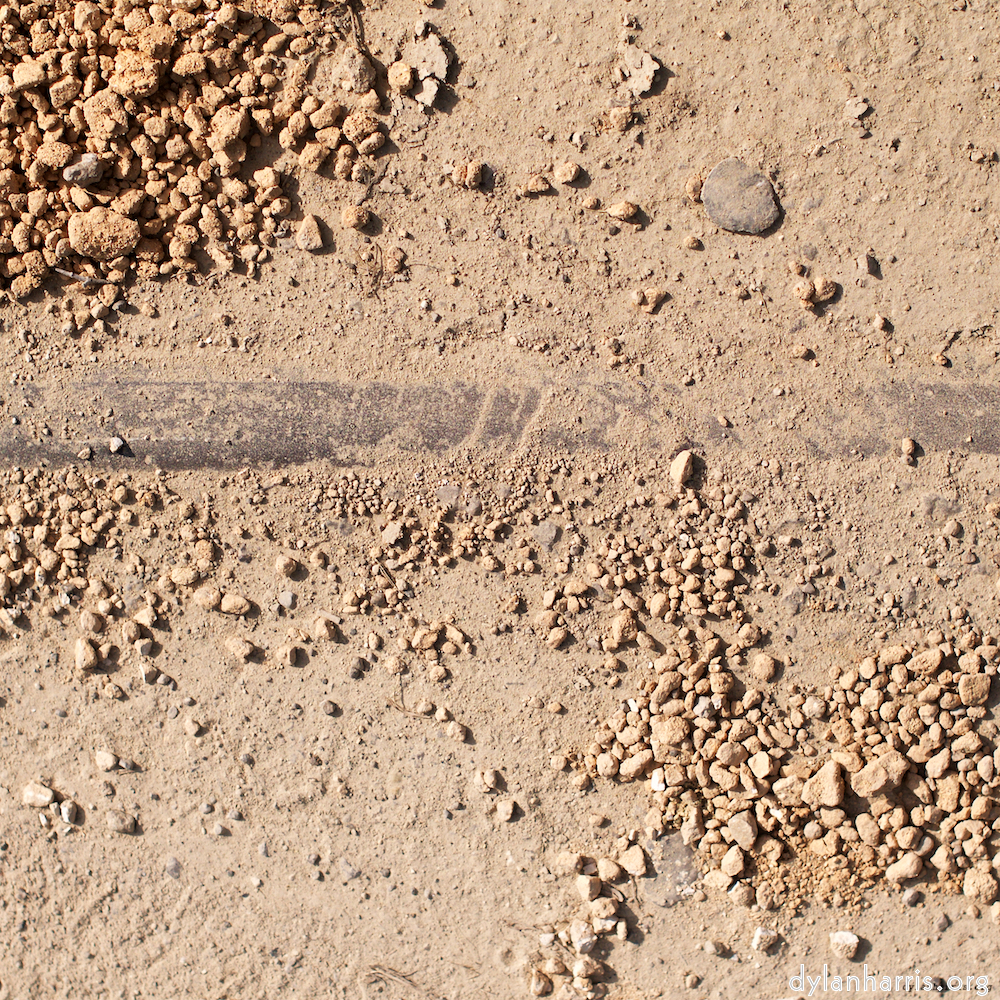 image: a rail just about visible in sand