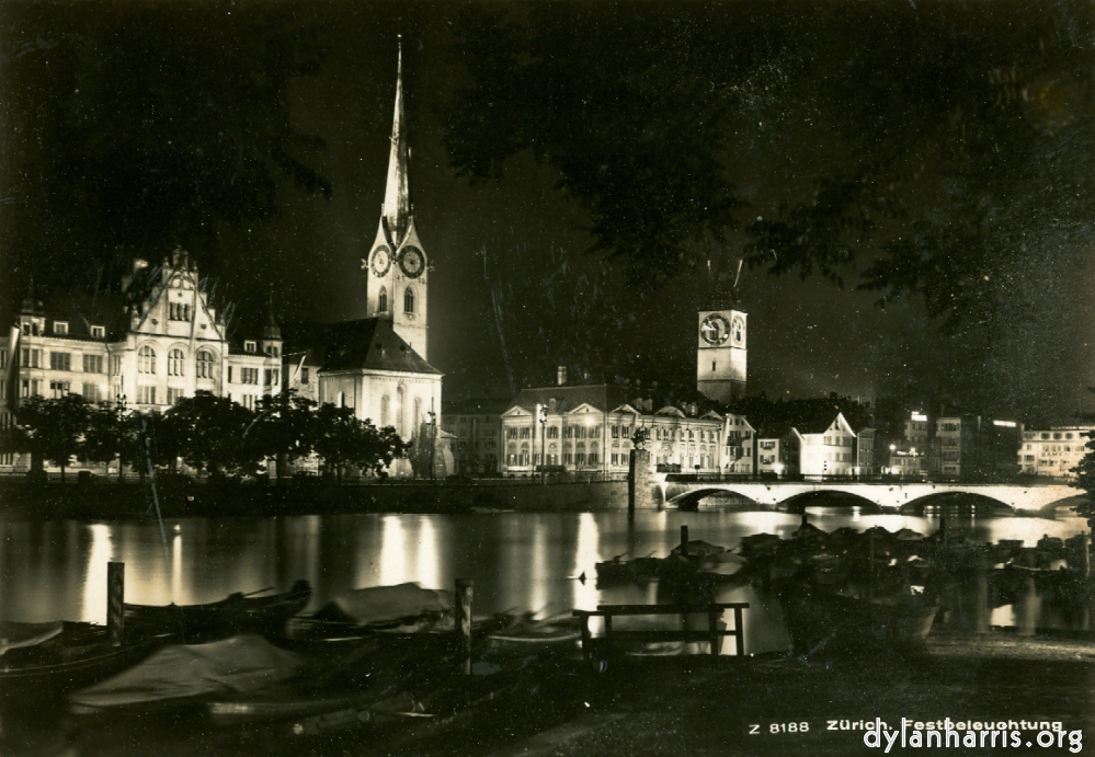 image: Postcard: Z 8188 Zürich. Festbeleuchtung [[ Zürich by Night: St. Peters Church and the Urania Observatory from the Lummatquai. ]]